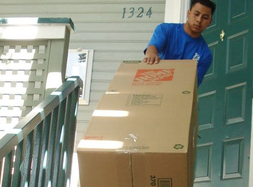 Spartan mover carries a moving box into a home.